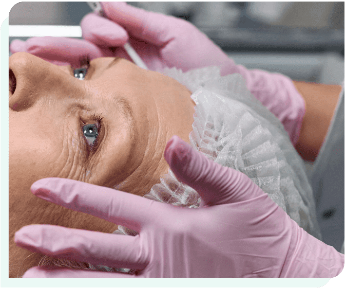 A woman is getting her face waxed