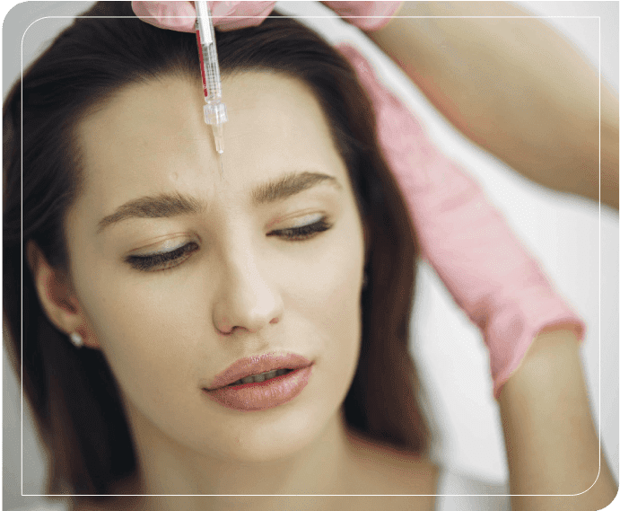 A woman getting botox injection in her forehead.