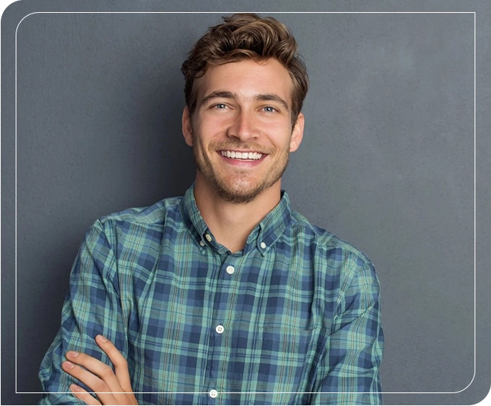 A man with his arms crossed smiling for the camera.