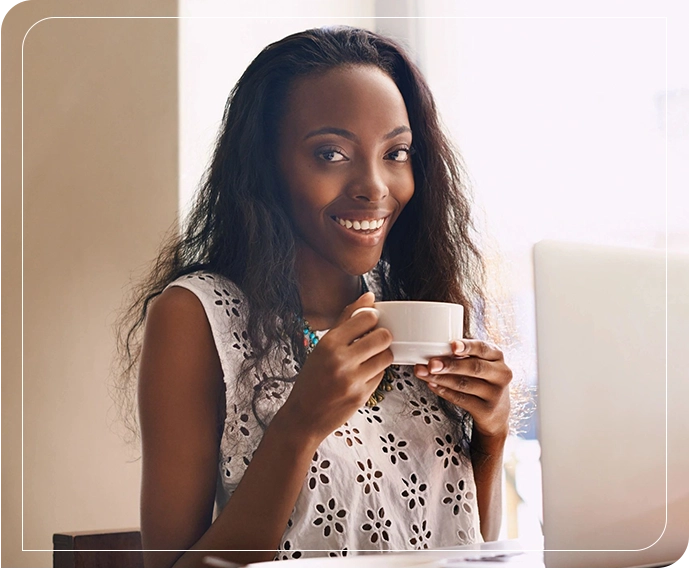 A woman holding a cup of coffee in her hands.